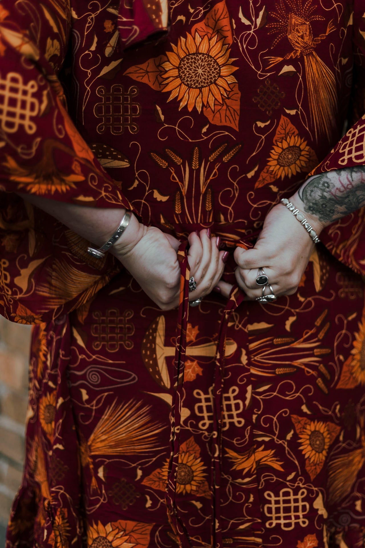 Person wearing a patterned garment with intricate designs.